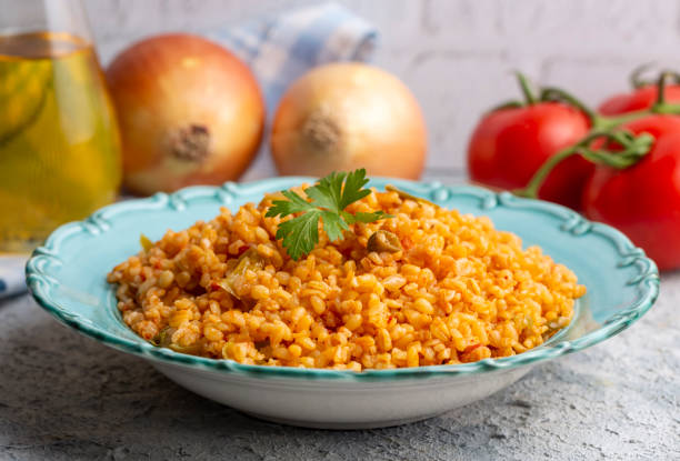 istock Traditional turkish bulgur pilaf with tomato sause in plate (Turkish name; meyhane pilavi) 1646549054