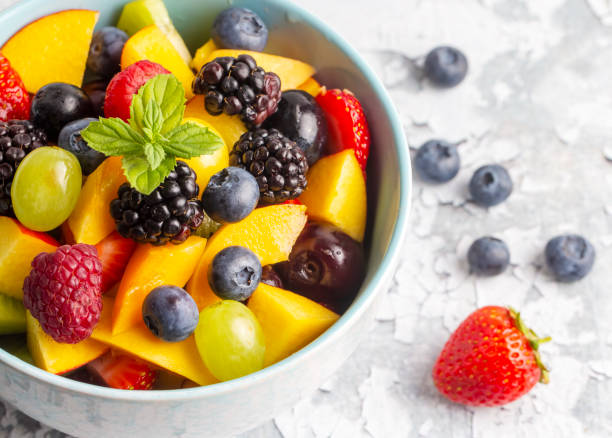 istock Dietary fruit salad with fresh summer fruits 1646550584