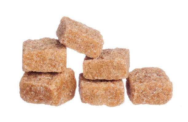 istock Brown cane sugar cubes isolated on white background 1646557404