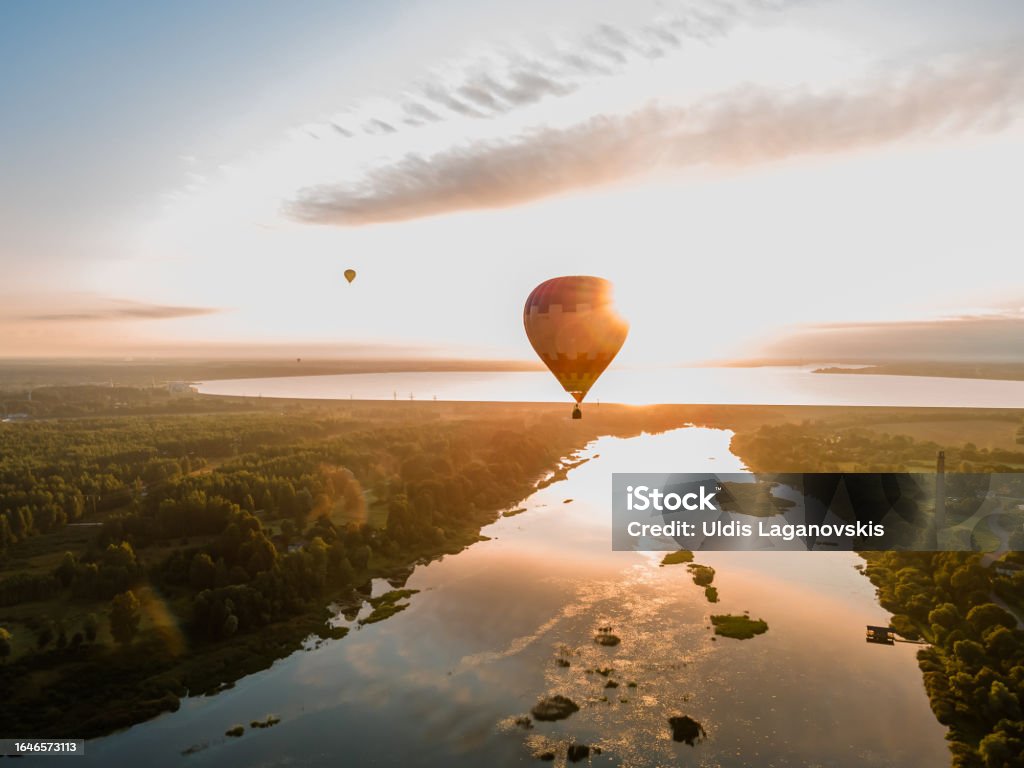 Hot air balloon is flying at sunrise or sunset. Aerial drone view Adventure Stock Photo