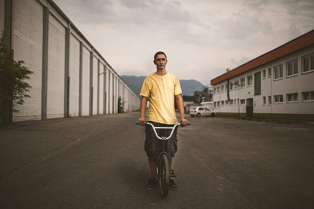 Portrait of a teenager with his BMX bike. Vintage look