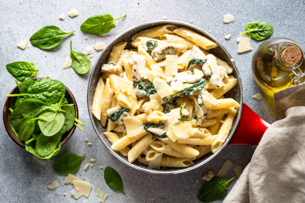 istock Pasta penne with chicken and spinach in creamy sauce. 1646588236