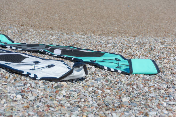 istock Several not inflated boards pumping up inflatable SUP on beach before the swim. 1646596600