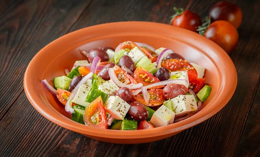 Horiatiki Greek salad with feta cheese in the bowl