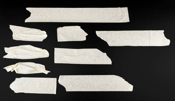 istock Set of various adhesive tape pieces on black background 1646599316