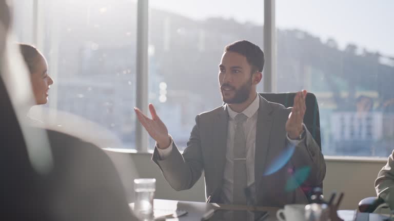 Team, lawyer and speech of man at meeting, conversation and leader speaking in office. Collaboration, group and attorney at table in discussion, planning or brainstorming legal business at sunset