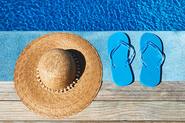 istock Blue slippers and hat by a swimming pool 164661125