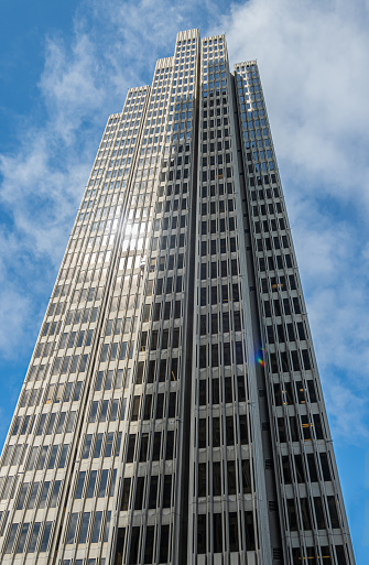 San Francisco, CA, USA - July 12, 2023: Tall 4 Embarcadero center building facade on corner of Clay and Drumm Street against blue cloudscape