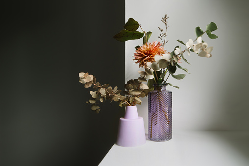Dried flowers in purple vases decorating a hosue