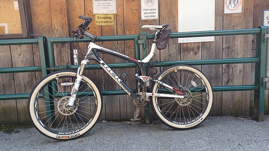 Hallstatt, Austria - June 7, 2023: A bicycle in a parking lot, on the street of Hallstatt town.