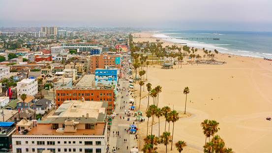 Aerial view of people walking on street amidst buildings and beach, Playa Del Rey, Los Angeles, California, USA.