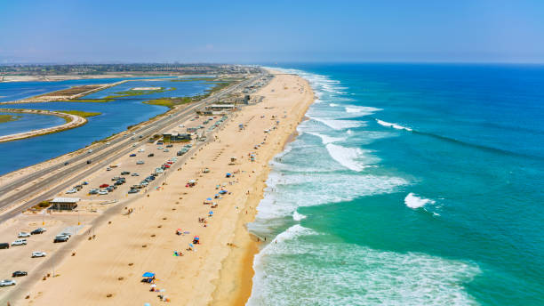 Aerial view of Newport beach with houses and car park along coastline, Orange County, California, USA.