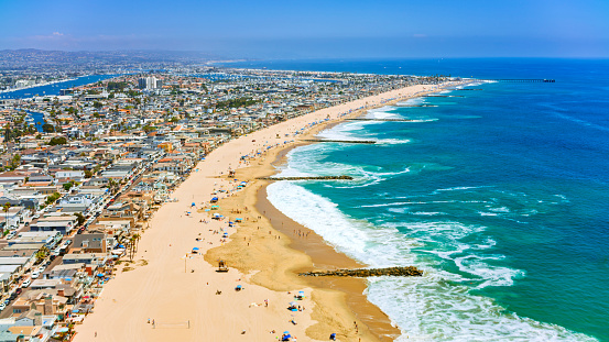 Aerial view of houses along Newport beach on sunny day, Orange County, California, USA.