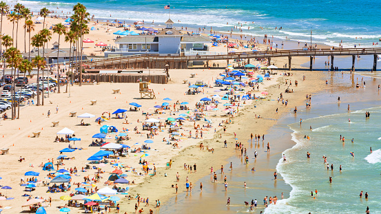 Aerial view of people enjoying at Newport beach on sunny day, Orange County, California, USA.
