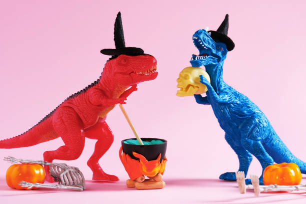 istock Red and blue dinosaur brewing potion on pink background. 1646656398