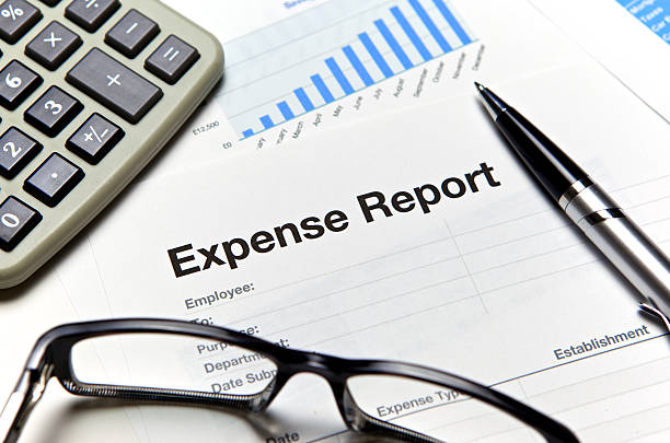 Close-up of an expense report with glasses and a calculator stock photo