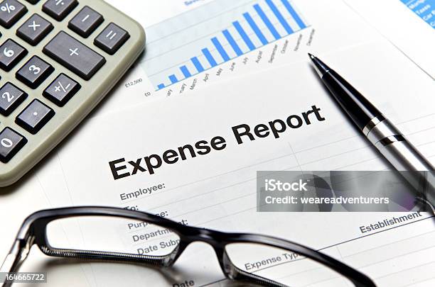 Closeup Of An Expense Report With Glasses And A Calculator Stock Photo - Download Image Now