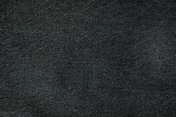 istock Texture of black jeans close up. Dark denim background. 1646657569