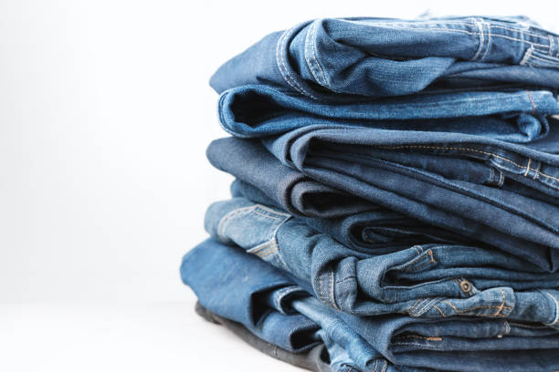 istock Denim jeans stacked on a white background. Trend clothes, shopping. 1646657572