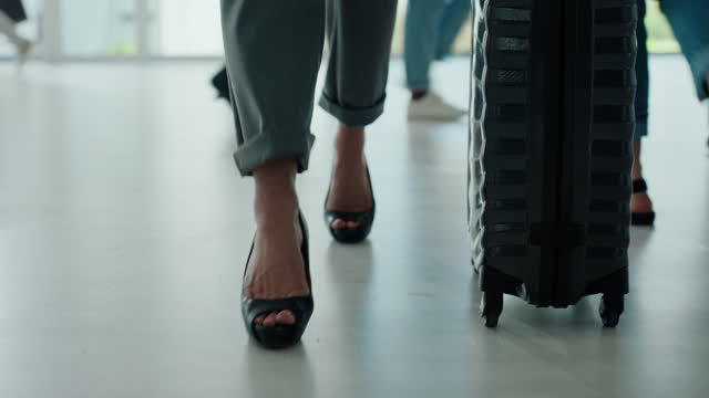 Feet, walking and luggage for travel at airport with a business woman in corporate fashion or heels. Shoes, suitcase and people in a building for conference, hotel or international flight or journey