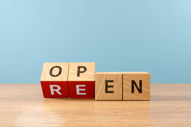 istock Wooden cube block flip over word REEN to OPEN on wood table, 3D render 1646675409