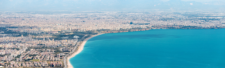 An aerial view of Antalya, Turkey, reveals its stunning coastline, inviting travelers to bask in the summer beauty of the Mediterranean.