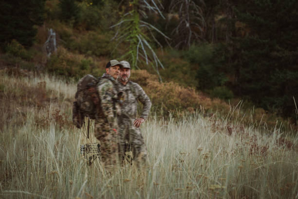 Two hunters hike at dawn while hunting elk