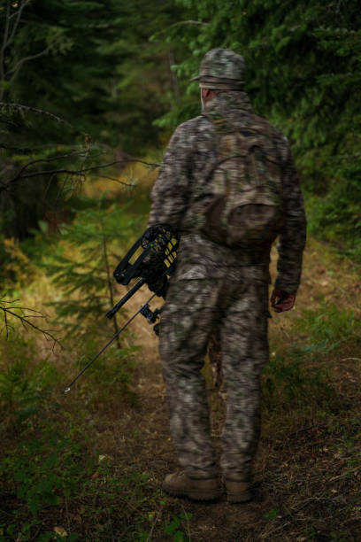 istock Crossbow hunter hiking in the forest 1646691717