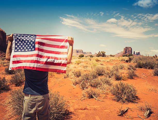 istock Tourist with flag on Monument valley National park 164670006
