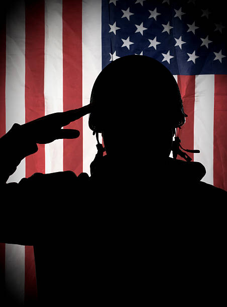 American (USA) soldier saluting to USA flag Silhouette of American (USA) soldier saluting to USA flag us military silhouette stock pictures, royalty-free photos & images