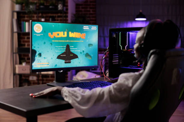 istock Woman celebrating winning videogame 1646719566
