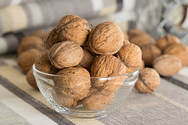 Glass bowl full of walnuts stock photo