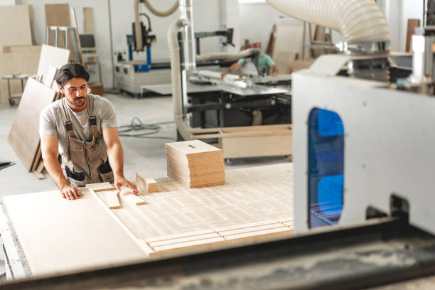 istock Young man doing woodwork in carpentry factory 1646734149