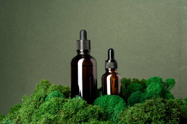 istock Vape smoking liquid bottles on moss background 1646752217