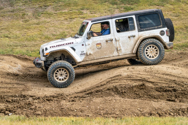 Jeep Wrangler, Rubicon model, on a muddy and bumpy training drive off-road course. stock photo