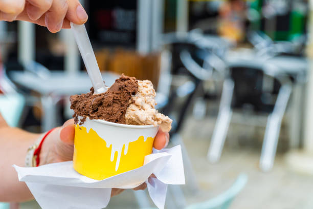 istock woman  holds cardboard cup ice cream 1646773855