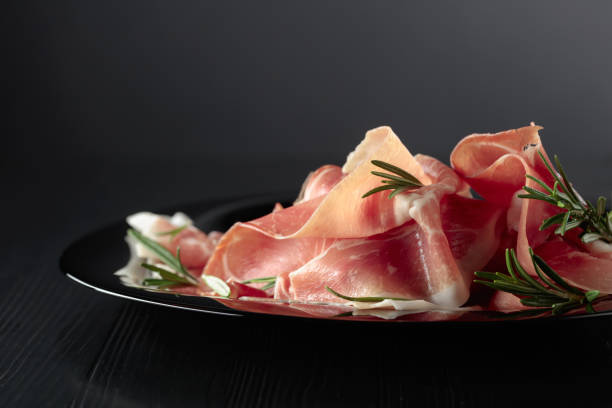 istock Italian prosciutto or Spanish jamon with rosemary. 1646779835