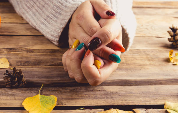 istock Autumn Chic. Cozy Knits and Trendy Nails. Rustic wooden background. Fall vibes 1646799840