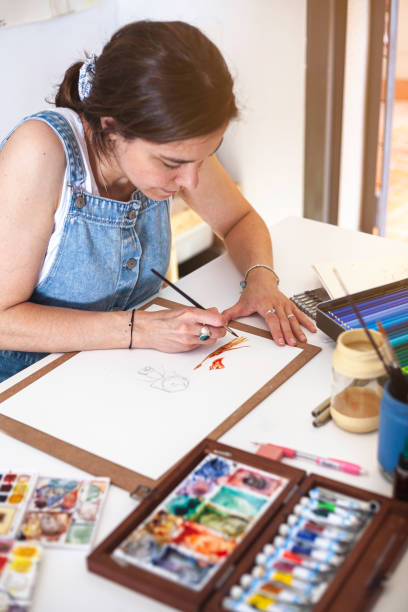 istock Vertical shot from above of illustrator doing watercolour work. 1646821210