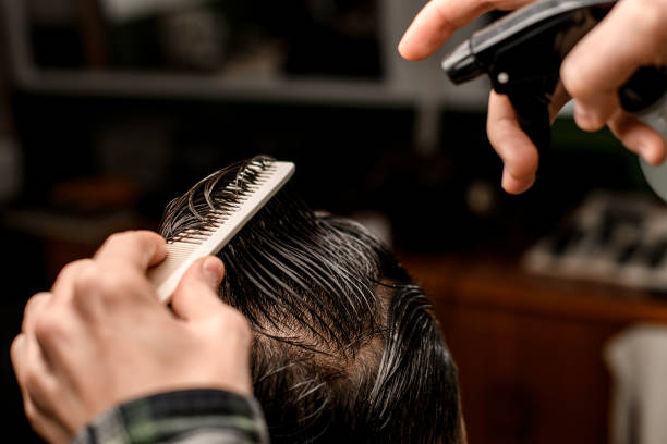 istock Selective focus on male client head with wet hair which barber combs 1646824438