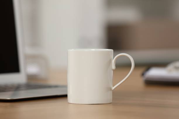 istock White ceramic mug and laptop on wooden table at workplace 1646846195