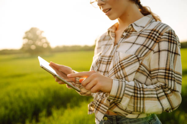 istock Farmer woman uses modern technology. 1646846845