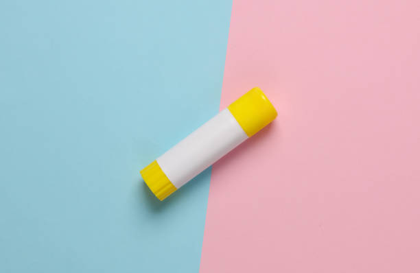 istock Glue stick for paper on pink blue background 1646846911