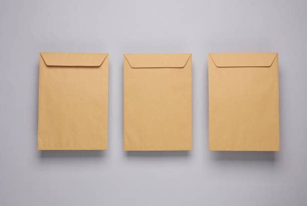 Craft postal envelopes on a gray background stock photo