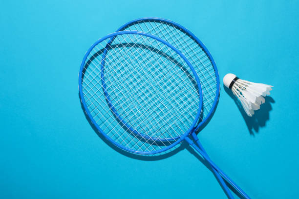 istock Badbintion racket with a shuttlecock on blue bright background 1646849683