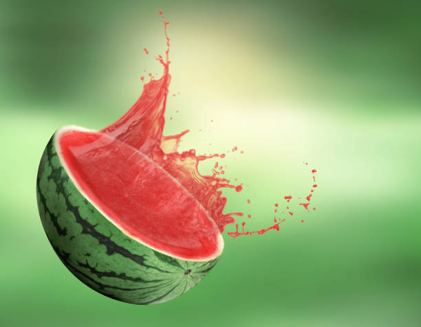 istock Watermelon with splashing juice on green background 1646854396
