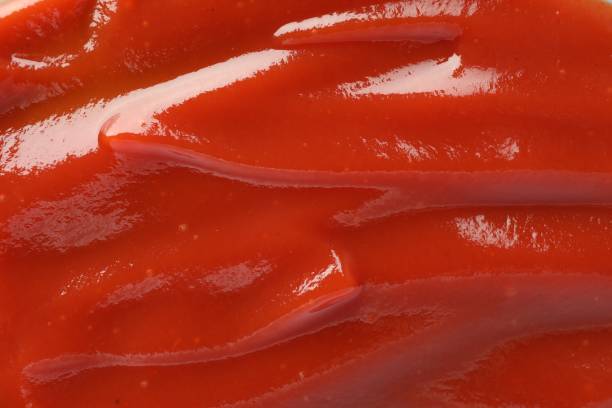 istock Tasty tomato ketchup as background, top view 1646854537