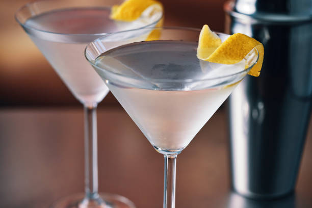 Martini Cocktail with Lemon Zest Martini Cocktail with Lemon Zest Gin stock pictures, royalty-free photos & images