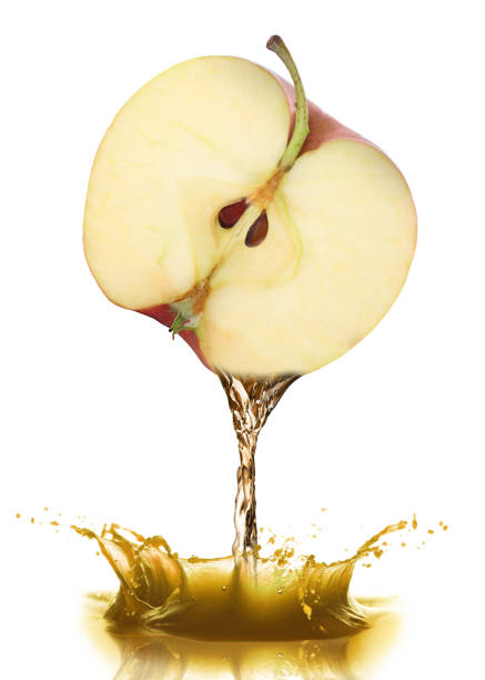 istock Pouring freshly squeezed juice from apple on white background 1646864749