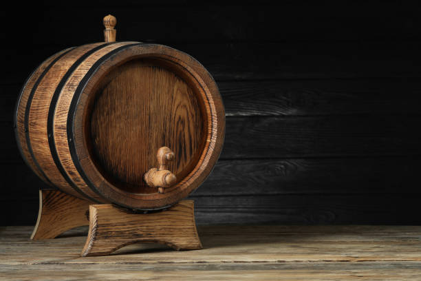 istock Wooden barrel with tap on table, space for text 1646864889